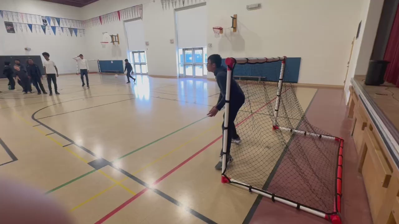 Load video: Children playing soccer with the Eznet in a school gymnasium