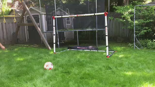 Load video: A youth kicking a ball repeatedly into his Eznet from a close vantage point, demonstrating its flexibility and strength.